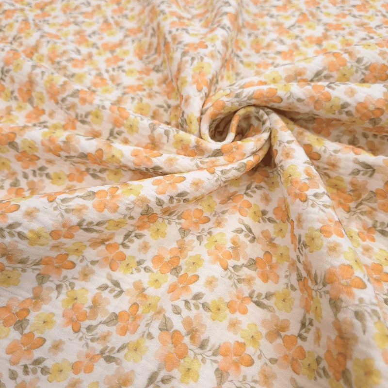 Mussola di Cotone Doppia Garza H 140 cm - FIORELLINI ARANCIO E GIALLI/LATTE