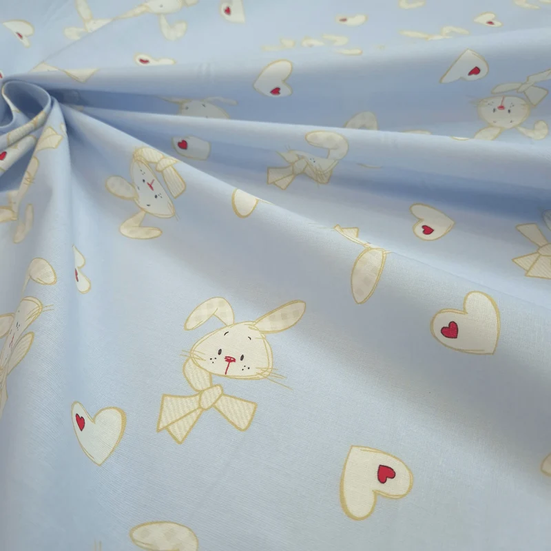 Tessuto Cotone H 160 cm - CONIGLIETTI E CUORI/AZZURRO TENUE