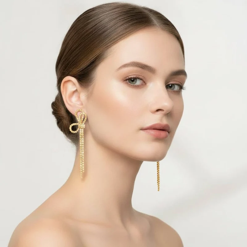Orecchini pendenti mezzo fiocco strass - Oro