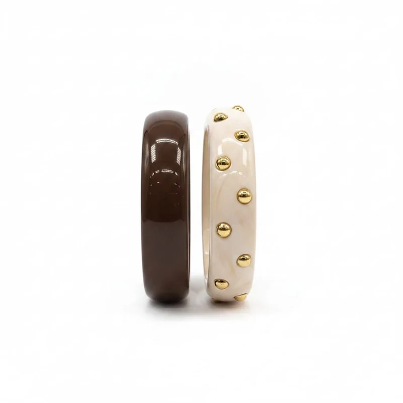 Bracciali rigidi in plastica con borchie - Moro