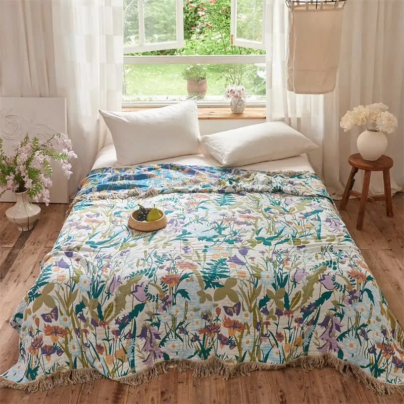 Coperta trapuntata reversibile in mussola con nappe botaniche