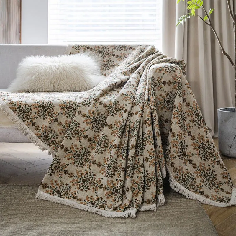 Copridivano con nappa in jacquard a fiori di prugna